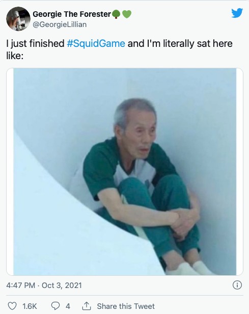 A user (@GeorgieeLillian) tweeted "I just finished #SquidGame and I'm literally sat here like:" and shared a meme of an old man from Squid Game sitting in a corner