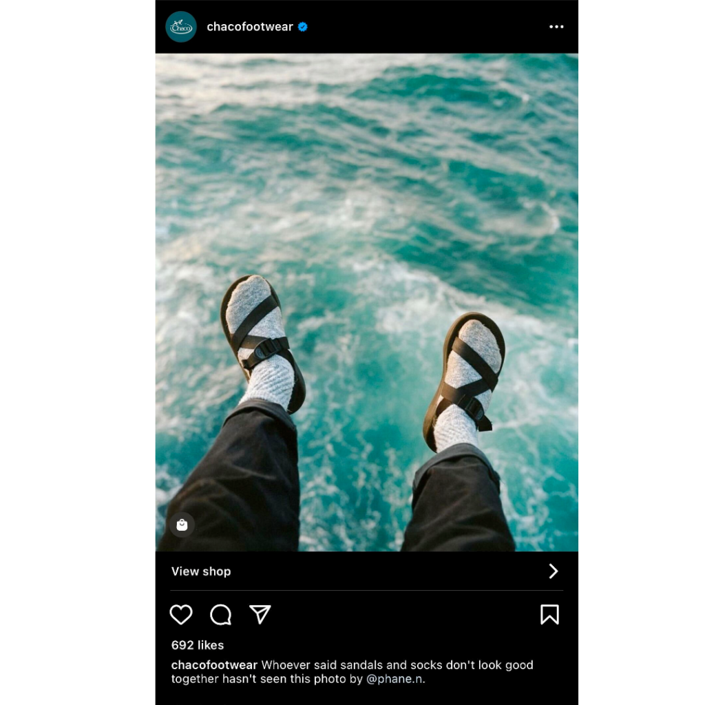 Chaco re-sharing UGC of a person's feet – wearing Chaco sandals – dangling over the ocean